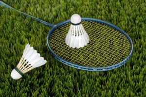 picture of two shuttlecocks and badminton racket