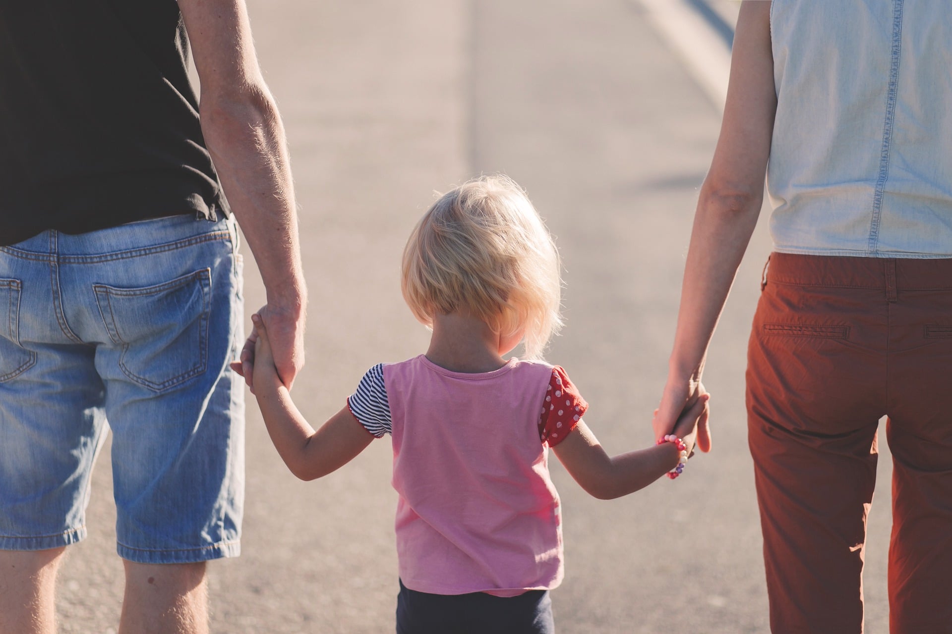 picture of child holding parents' hands