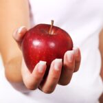 in picture a hand with an apple