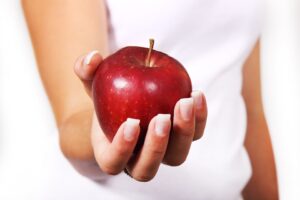 in picture a hand with an apple