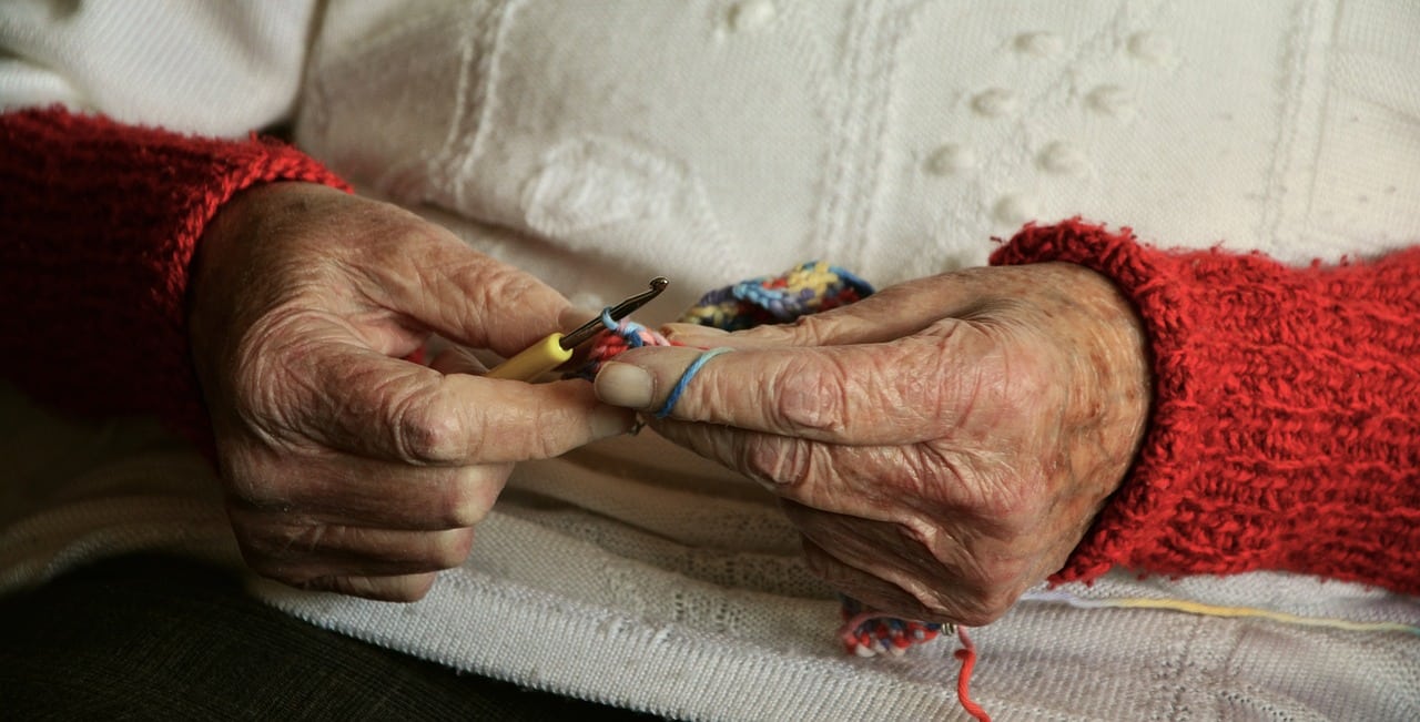 old woman's hands crocheting