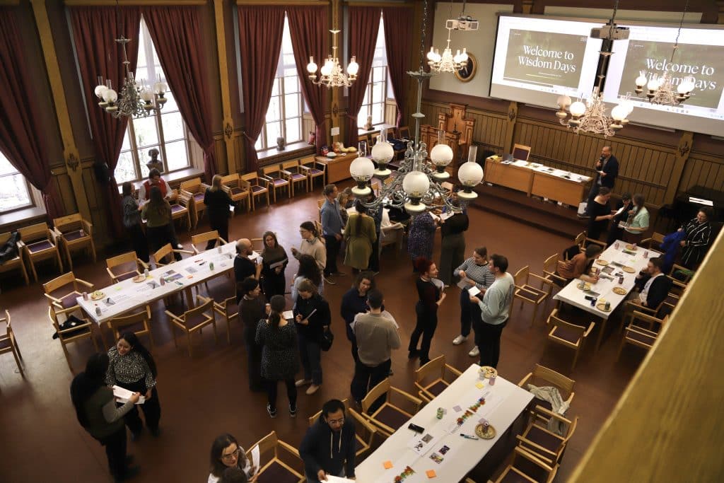 People standing in the room talking with each other.